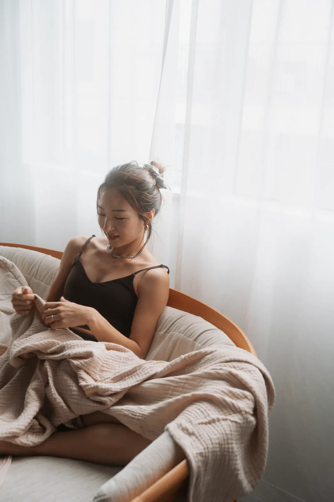 窓辺の椅子に座る女性のポートレート